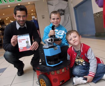 Research student Emre Ozbilge, with Eoin Doherty and his friend Caolan Cooper, working a mobile pioneer robot during a display by the University of Ulster’s Intelligent Systems Research Centre (ISRC) at Foyleside shopping complex. It was a “taster” event for “Discovery Day” this Saturday (Sept 25) when the ISRC